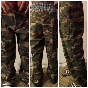 Grade school boy army camouflage trousers.